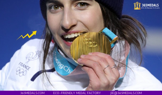 French skier Perrine Laffont bites her gold medal