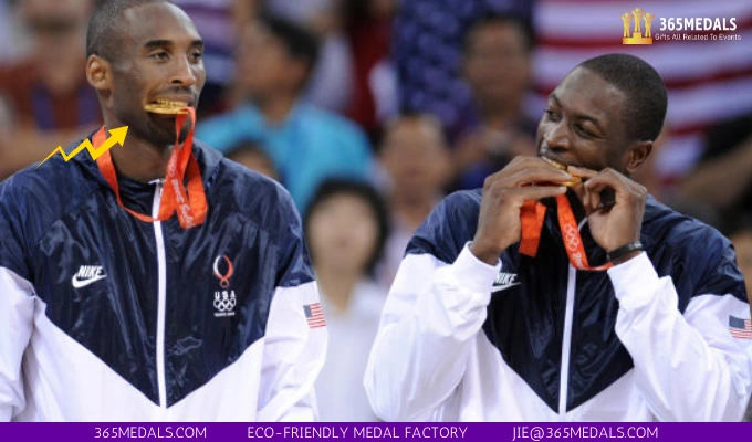 Kobe Bryant and Dwyane Wade bite their medals