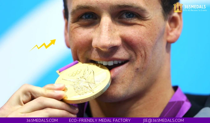 US swimmer Ryan Lochte bites one of his Olympic medals